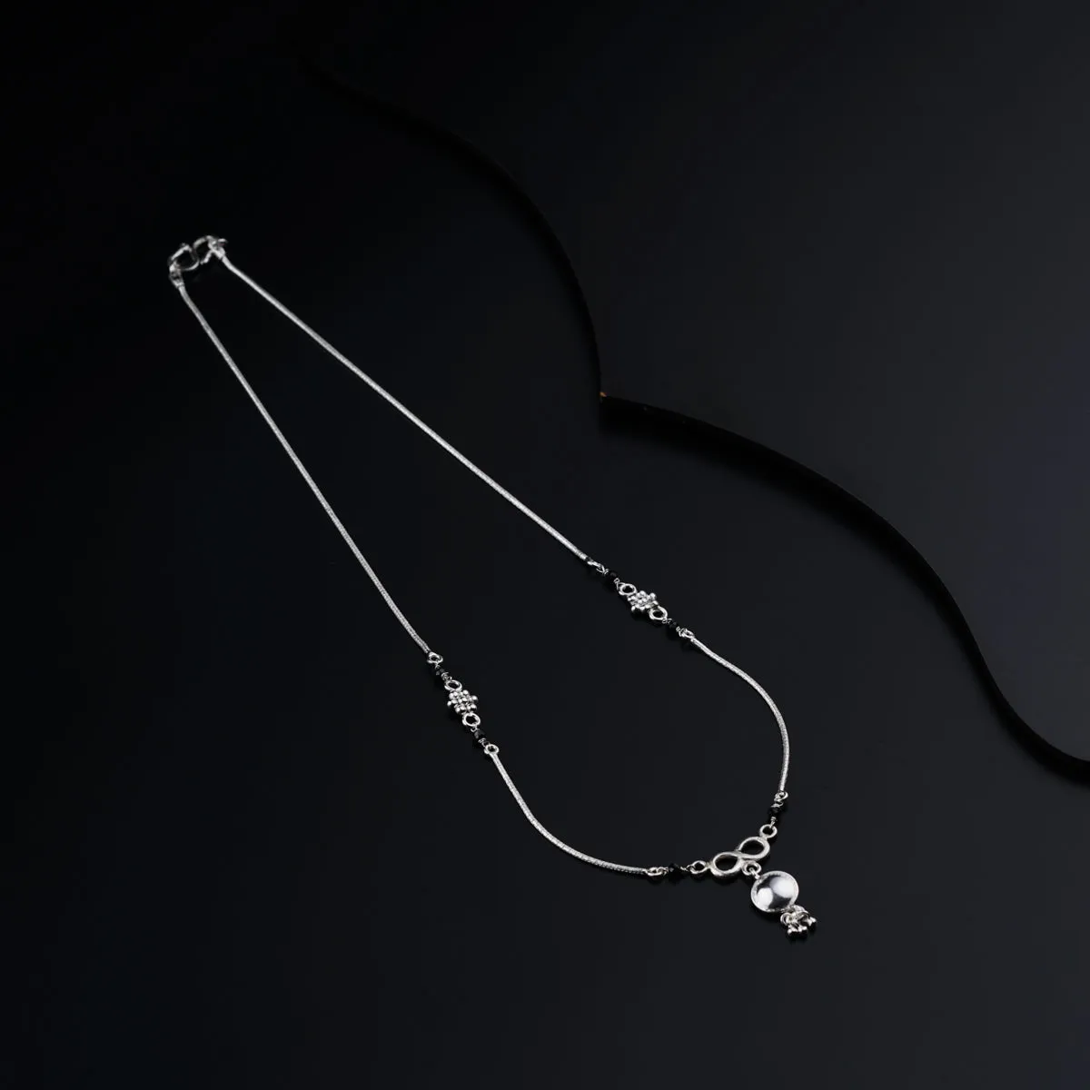 Silver mangalsutra with kudi and infinity motif