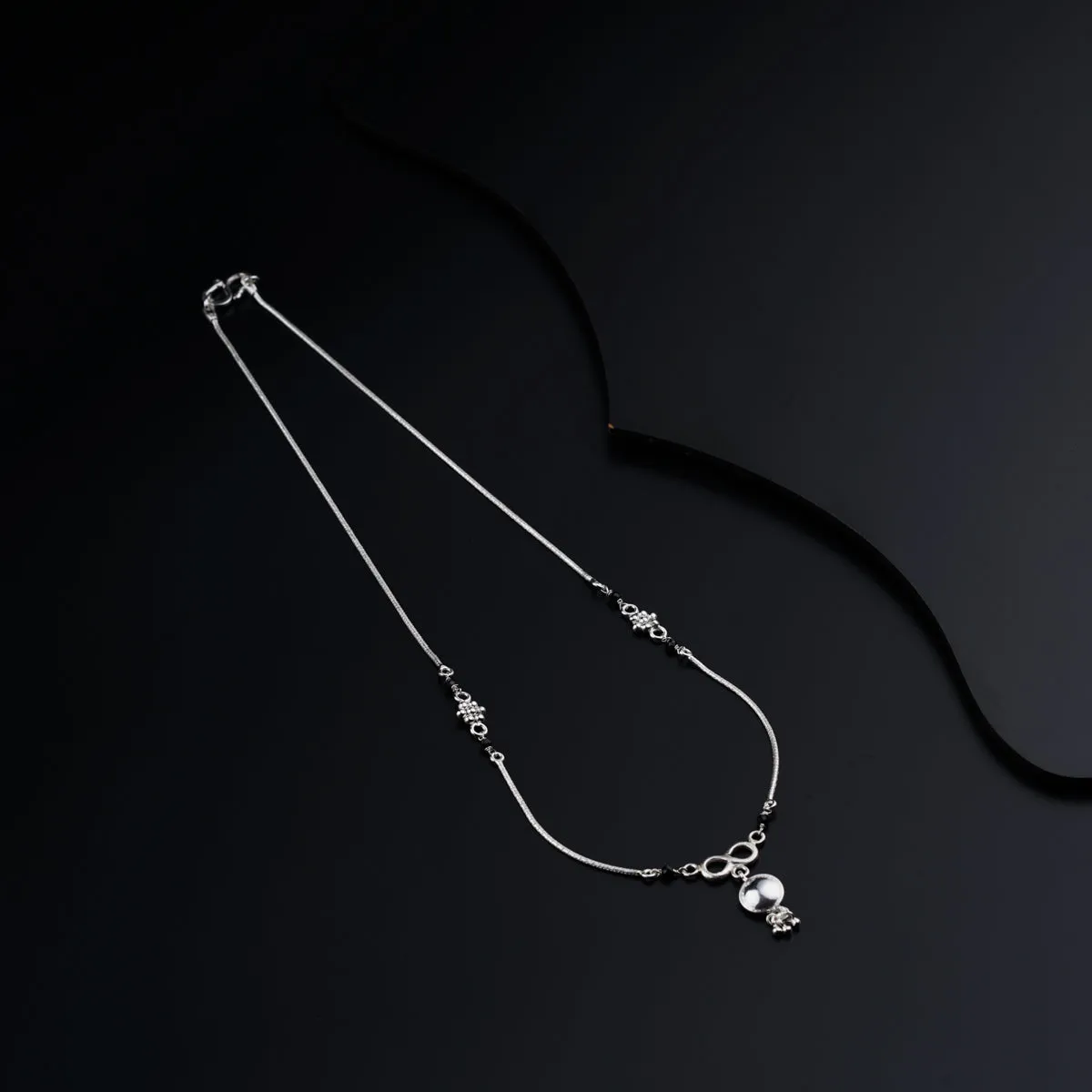 Silver mangalsutra with kudi and infinity motif